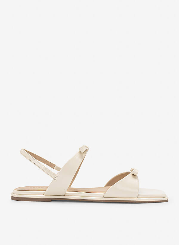 Sandal đế bằng họa tiết nơ cá tính